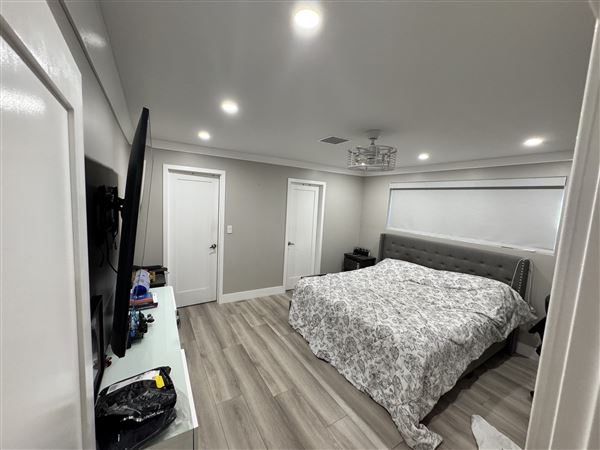 Modern Valley Family Home (2/25/2026 - Credits: Modern open-concept kitchen with waterfall marble island  Clean recessed lighting throughout  Neutral gray + white palette (camera friendly)  Large dining setup (great for commercial shoots)  Sliding glass doors connecting indoor/outdoor  Outdoo)