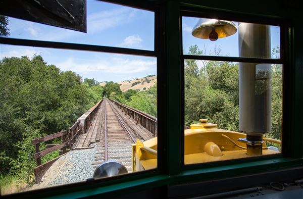 Niles Canyon Railway & Sunol Depot - The Niles Canyon Railway’s M200 railbus rolls over the Arroya de la Laguna bridge east of Sunol as the motocar works its way east toward the museum’s current end of operating trackage at Happy Valley Bridge in Pleasanton, CA. (3/18/2026 - Credits: Christopher Hauf – Niles Canyon Railway)