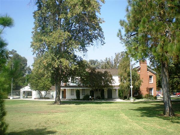 Shadow Ranch Park - Shadow Ranch, a historic ranch house, and a Los Angeles City Park, in the western San Fernando Valley, Southern California. Built in redwood, surrounding an existing adobe, by Alfred Workman during 1869-1872. He also imported the first Blue Gum Eucalyptus trees (Eucalyptus globulus) to California. Their shadow patterns on the residence inspired a later owner to name it Shadow Ranch, and towering Blue Gums are now one of the state's iconic symbols. Los Angeles Historic-Cultural Monument #9 (9/21/2008 - Credits: by Los Angeles - Own work (https://en.wikipedia.org/wiki/Shadow_Ranch#/media/File:Shadow_Ranch,_West_Hills.jpg) [https://creativecommons.org/licenses/by-sa/3.0/])