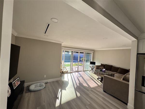 Modern Valley Family Home (2/25/2026 - Credits: Modern open-concept kitchen with waterfall marble island  Clean recessed lighting throughout  Neutral gray + white palette (camera friendly)  Large dining setup (great for commercial shoots)  Sliding glass doors connecting indoor/outdoor  Outdoo)